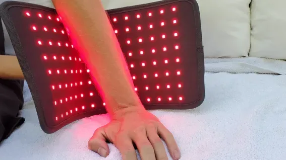 Glokore Therapy Wrap red light session on arm and wrist